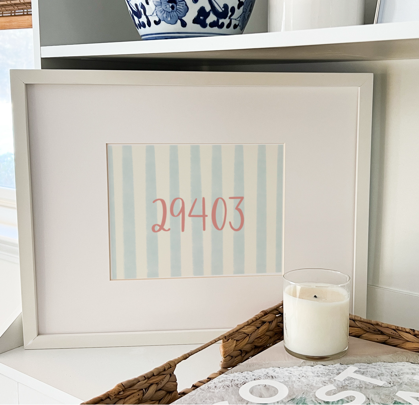 Framed artwork with numbers on a shelf with decorative items